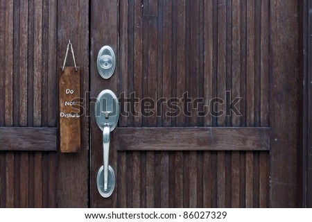 Do Not Disturb\' sign hanging from hotel door handle