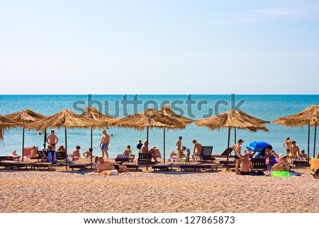 KOKTEBEL, UKRAINE - JULY 6: People swim and sunbathe at the city beach of Koktebel  on July 6, 2012 in Koktebel, Ukraine. The beach is one of the most popular holiday resorts in Crimea, Ukraine.