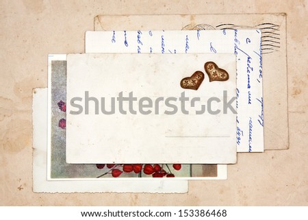 old letters, empty post cards and two hearts, vintage background