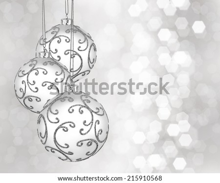 Three beautiful silver christmas balls on a silver background