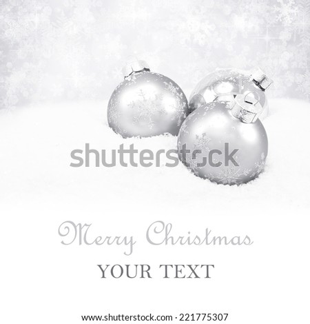 Three silver christmas balls on silver background