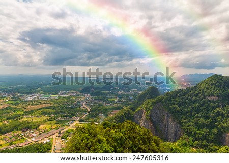 beautiful landscape with cloudy blue sky and rainbow