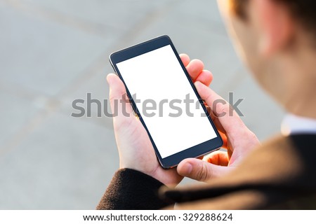 Businessman using his Mobile Phone outdoor, close up