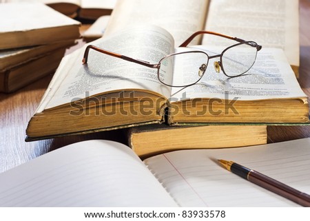 Vintage books and glasses on wooden table