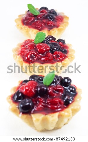 Three fresh blackberry and raspberry cakes