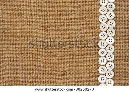 Nacre buttons on fabric texture background