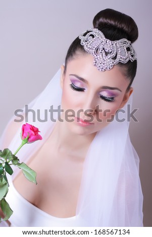 Woman portrait with rose. Professional wedding make-up.