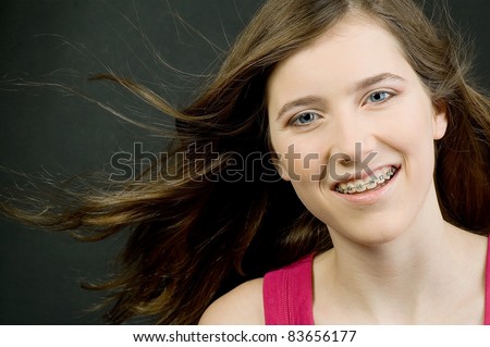 Teenage girl with braces smiling at the camera