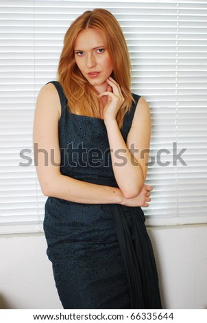 Blonde Glamour Woman On Her Workplace Over White Venetian Blinds