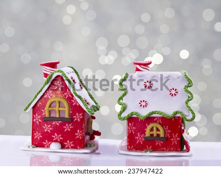 Christmas house decorated with multicolored glaze or background with light beams and Santa at the door.