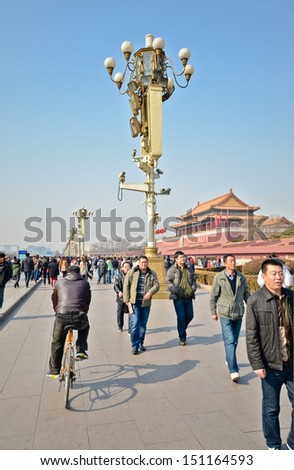 BEIJING - FEB 20: Early morning tourists start to flock at Tian An Men Square on February 20, 2012 in Beijing, China. Tiananmen Square is the third largest city square in the world.