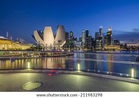 SINGAPORE, SINGAPORE - MAY 13: The skyline of Singapore lit up at night with the ArtScience Museum in the foreground. Photo taken May 13, 2014 in Singapore, Singapore.