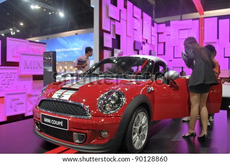 BANGKOK - DECEMBER 3: Mini\'s booth showing the latest version known as MINI COUPE among people at Motor Expo, Impact on December 3, 2011 in Bangkok, Thailand.