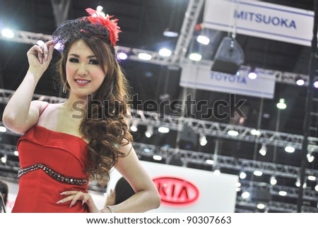 BANGKOK - DECEMBER 3: Female presenters model at the KIA booth during Bangkok International Motor Show at Impact Challenger on December 3, 2011 in Bangkok, Thailand.