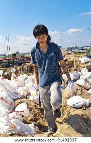 BANGKOK THAILAND - OCT 31: Thai volunteers made sand bags for protecting Bangkok from flood on October 31,2011 in Bangkok Thailand