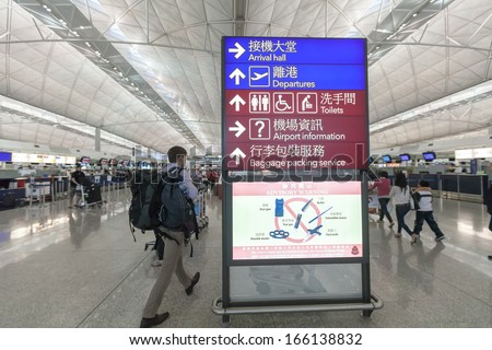 hongkong- NOVEMBER 11: A traveler views a departures board at Hong Kong airport on November 11, 2013 in Hong Kong, China. The Hong Kong airport handles more than 70 million passengers per year.