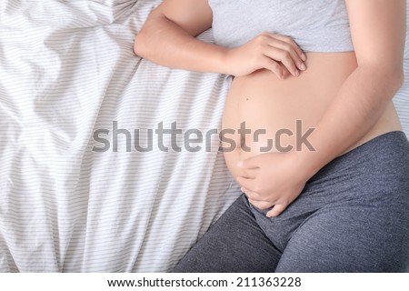 A shot of a beautiful pregnant Asian woman,5 month