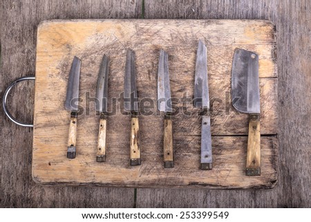 wood cutting board and rusty knife
