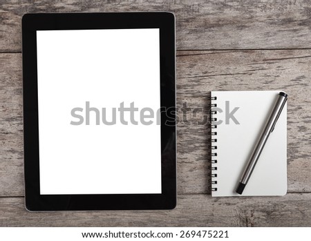 empty tablet with note paper and coffee on the wooden table