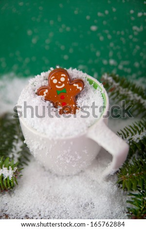 Christmas decoration arranged in different scenes.Gingerbread man in coffee cup.