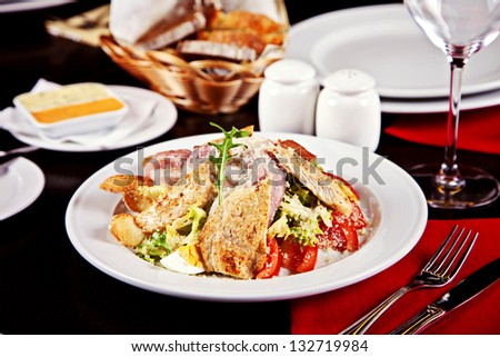 Caesar salad served on plate in restaurant