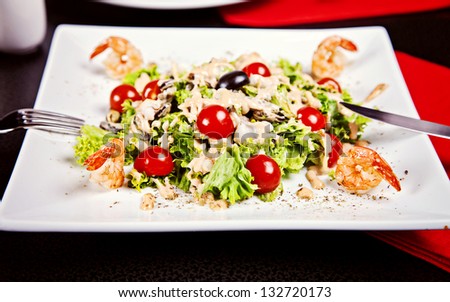Salad with shrimp, tomatos and white sauce served in restaurant