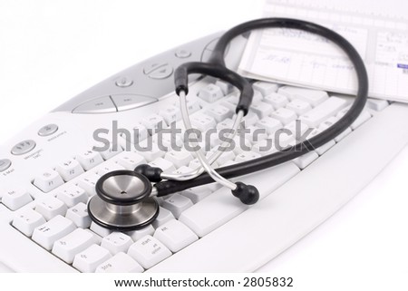 Stethoscope and medical record lying on a keyboard. Focus on the foreground.