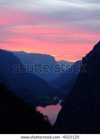 The colors of the sunset reflecting in a mountain lake - Aurlandsdalen - Norway