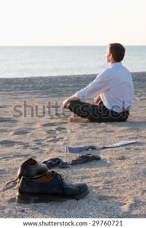 Businessman relaxing on beach - Focus on the shoes in the foreground