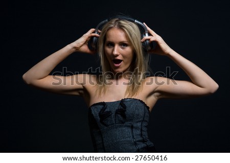 Young woman listening to music on classic headphones
