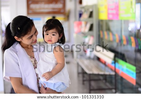 Asian doctor hold crying baby girl