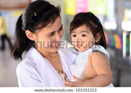 Asian doctor hold crying baby girl