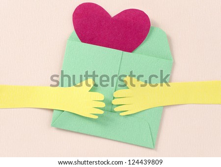 hand and heart envelope paper cutting on pink background