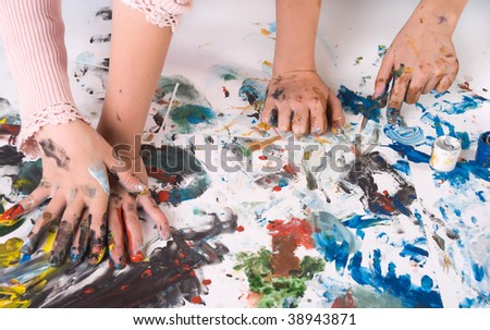 The dirty colored hands (of two girls)