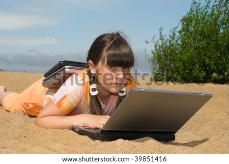 The girl  with laptops on sea sand