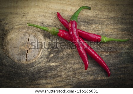 Chili Peppers /  Chili peppers isolated on wood texture