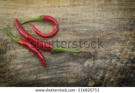 Chili Peppers / Chili peppers isolated on wood texture