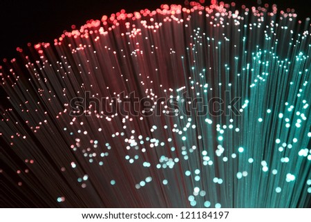 colorful illuminated plastic optical fibers in dark back