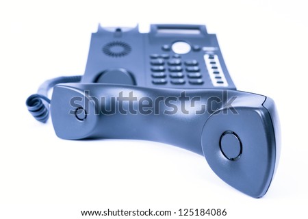 simple blue business phone on white background. telephone receiver in the front