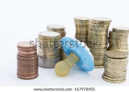 pacifier with hard money  in light background.