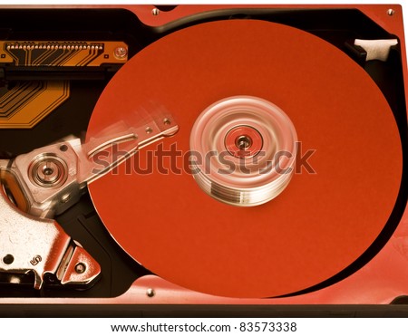 red platter from open hard drive with moving head