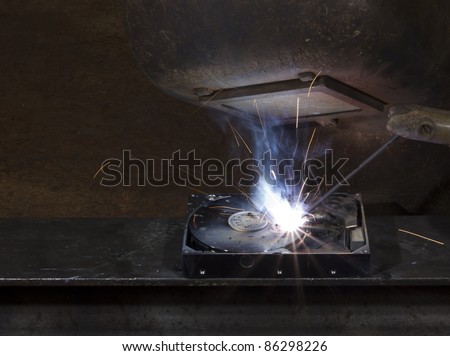 electrical welding on open hard disk drive. Protective shield of steel worker. Copy space