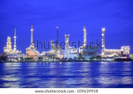 Landscape of river and oil refinery factory between sun rise time in Chao praya river, Bangkok, Thailand.