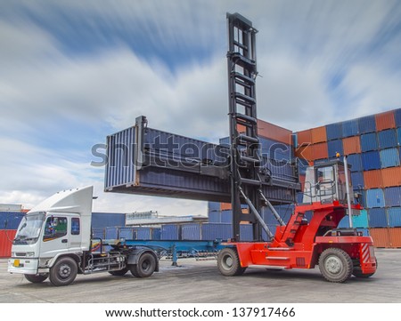 Crane lifter handling container box loading to truck