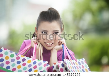 A shopping black woman carrying shopping bags outdoor