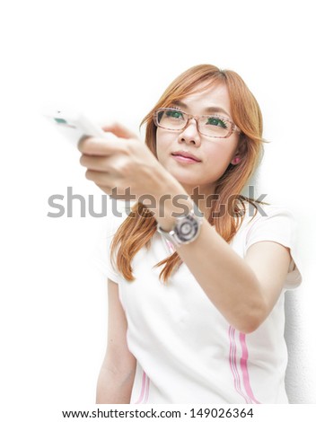 woman with an infrared remote control pointing it at the viewer while changing channels on the television