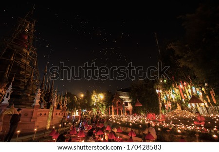 CHIANG MAI, THAILAND - DEC 31: New year festival, Buddhist monk fire candles to the Buddha on Dec 31, 2013 in Phan Tao Temple, Chiangmai, Thailand.