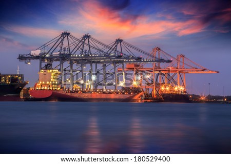Container Cargo freight ship with working crane bridge in shipyard at dusk for Logistic Import Export background Container Cargo freight ship with working crane bridge in shipyard at dusk for Logistic Import Export background