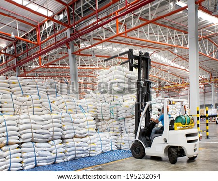 Forklift loader with big bag of sugar in distribution warehouse