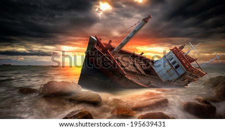 Fishing boat beached in storm in the stone beach, sea, island.